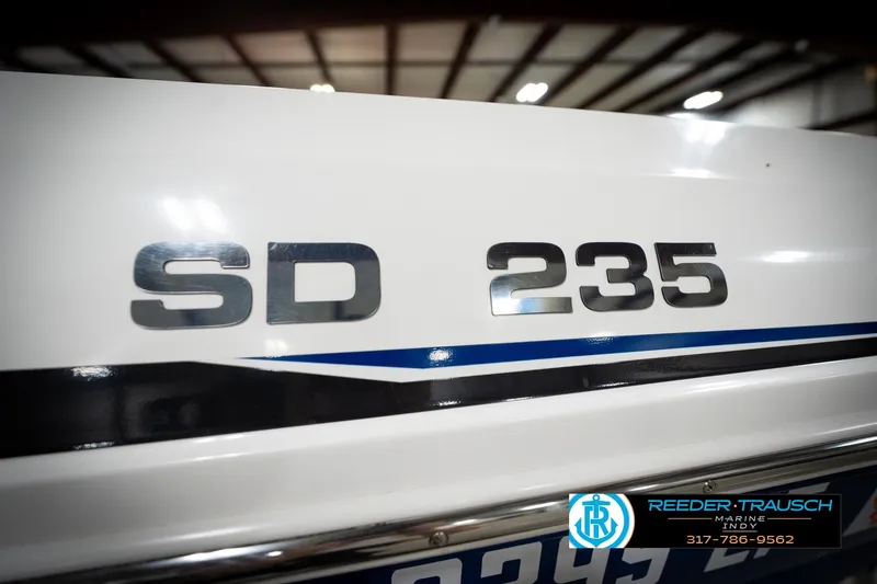 Slide: The Image of 2022 Hurricane 235RD boat with SD 235 branding, showcased indoors. - 53