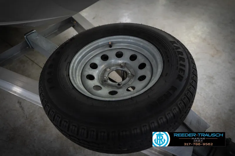 Slide: The Image of Trailer wheel on a 2022 Hurricane 235RD boat, displayed at Reeder Trausch Marine. - 55