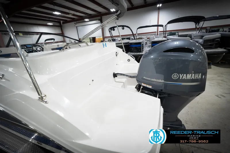 Slide: The Image of 2022 Hurricane 235RD boat with Yamaha engine in showroom, Reeder-Trausch Marine logo visible. - 57