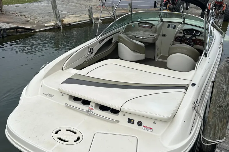 Slide: The Image of 2006 Sea Ray 220 Select boat docked, featuring spacious seating and sleek design. - 6