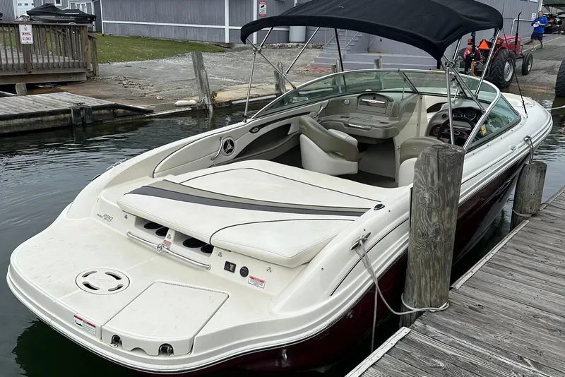 Slide: The Image of 2006 Sea Ray 220 Select boat docked, featuring sleek design and spacious interior. - 8