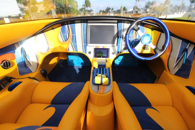 Slide: The Image of Vibrant interior of 2007 MTI 40RP boat with yellow and blue accents. - 10