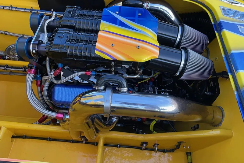 Slide: The Image of High-performance engine of a 2007 MTI 40RP boat, featuring vibrant yellow and blue accents. - 12