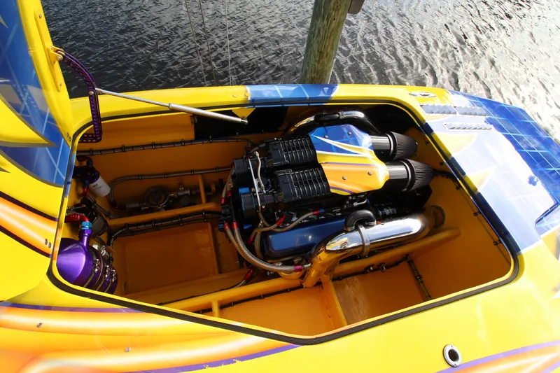 Slide: The Image of 2007 MTI 40RP boat engine compartment with vibrant yellow and blue design. - 15