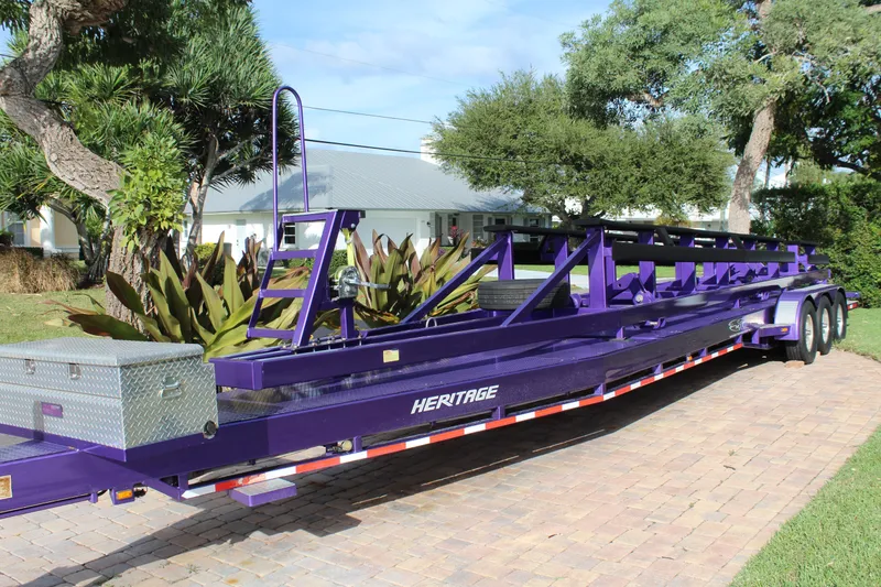 Slide: The Image of Purple MTI 40RP 2007 trailer parked on brick driveway, surrounded by lush greenery. - 28