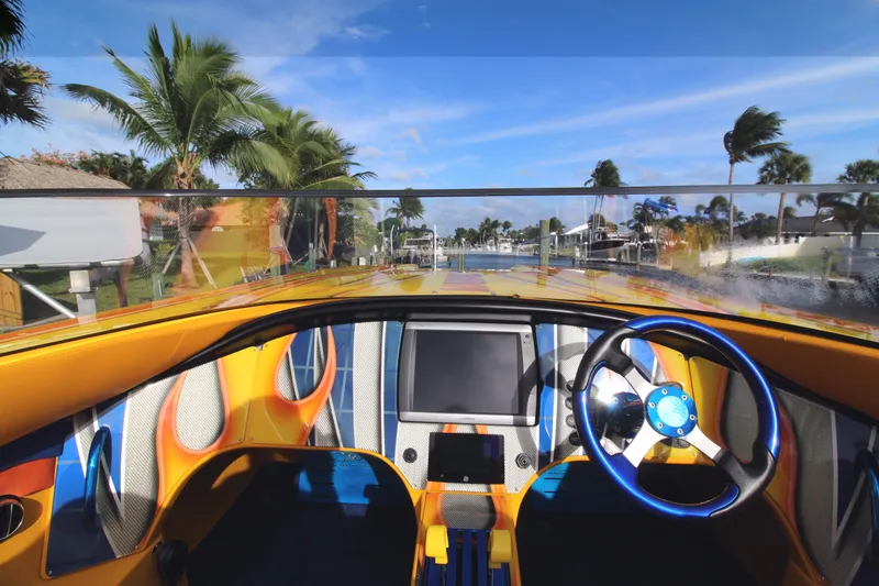 Slide: The Image of Interior view of a 2007 MTI 40RP boat with vibrant dashboard and steering wheel. - 4