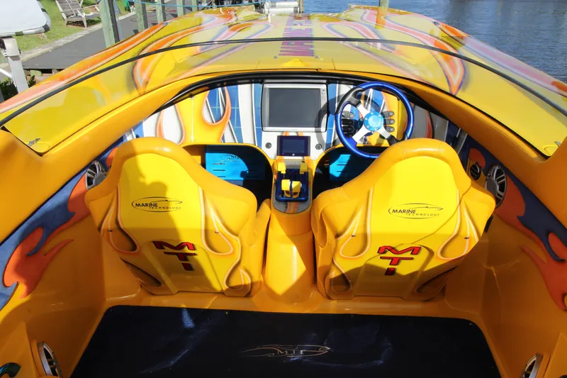 Slide: The Image of 2007 MTI 40RP boat interior with vibrant yellow seats and modern dashboard. - 5