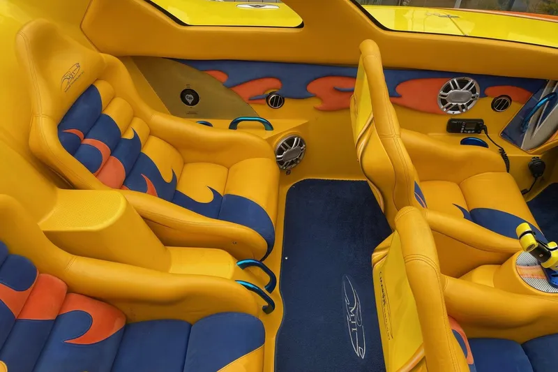 Slide: The Image of Vibrant yellow and blue interior of a 2007 MTI 40RP boat with custom seating. - 7