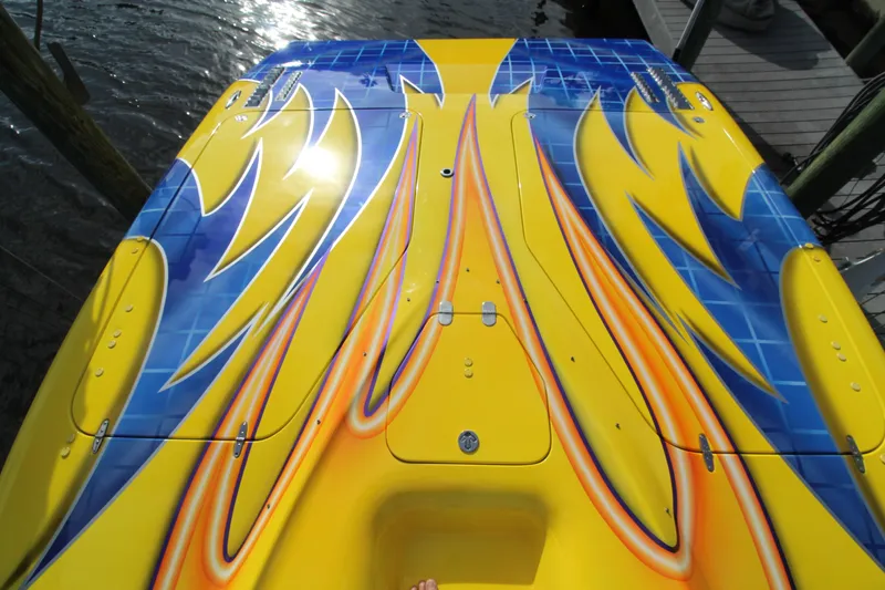 Slide: The Image of Colorful 2007 MTI 40RP boat with vibrant yellow, blue, and orange design. - 9