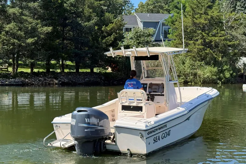 Slide: The Image of 2008 Grady-White Fisherman 222 boat on calm water, surrounded by lush greenery. - 1
