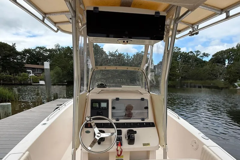 Slide: The Image of 2008 Grady-White Fisherman 222 boat interior, docked by a scenic waterfront. - 10
