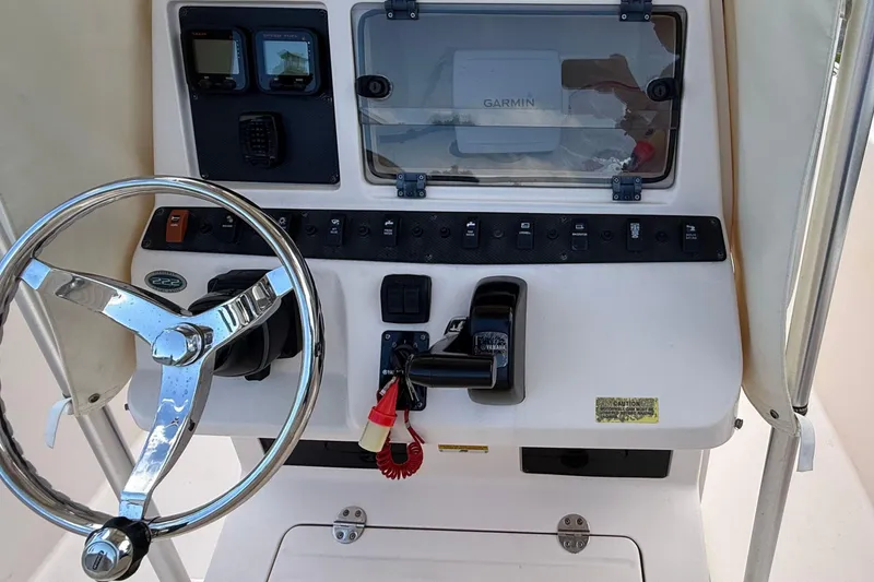 Slide: The Image of 2008 Grady-White Fisherman 222 boat dashboard with steering wheel and controls. - 11