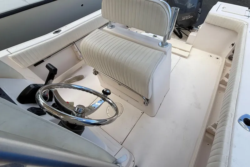 Slide: The Image of 2008 Grady-White Fisherman 222 boat interior with steering wheel and seating. - 12