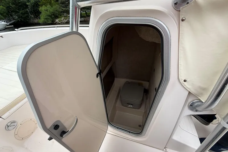 Slide: The Image of 2008 Grady-White Fisherman 222 boat cabin with open door and visible toilet. - 14