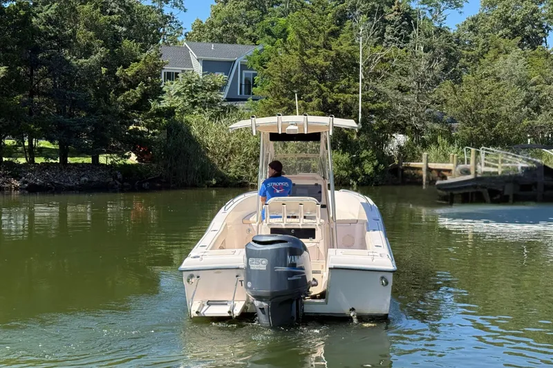 Slide: The Image of 2008 Grady-White Fisherman 222 boat on calm water near a wooded shoreline. - 2