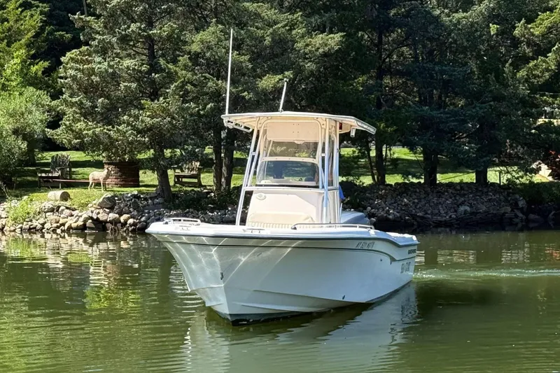 Slide: The Image of 2008 Grady-White Fisherman 222 boat on a serene lake with lush greenery. - 3