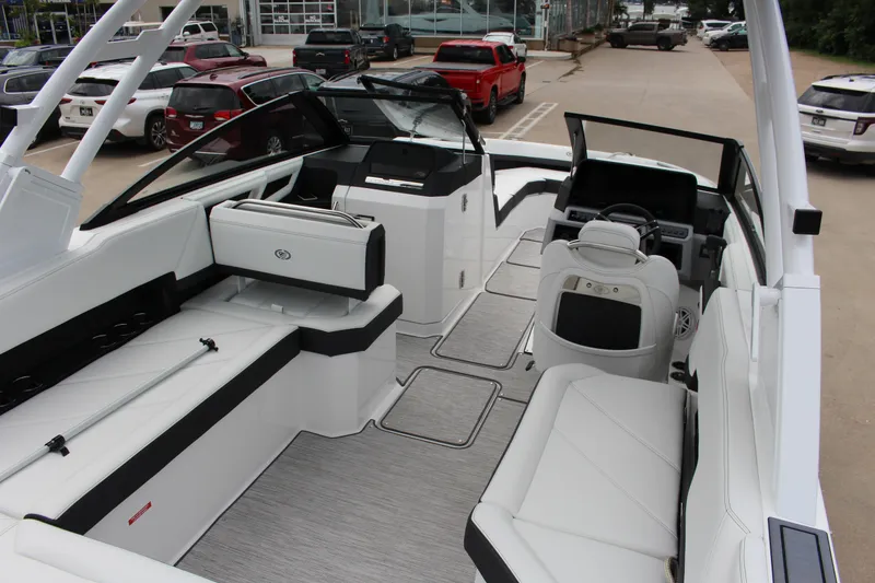 Slide: The Image of 2025 Cobalt R8 boat interior with sleek white seating and modern dashboard design. - 11