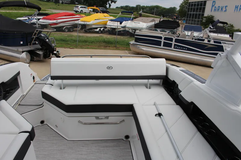 Slide: The Image of 2025 Cobalt R8 boat interior with white seating, docked near other boats. - 13