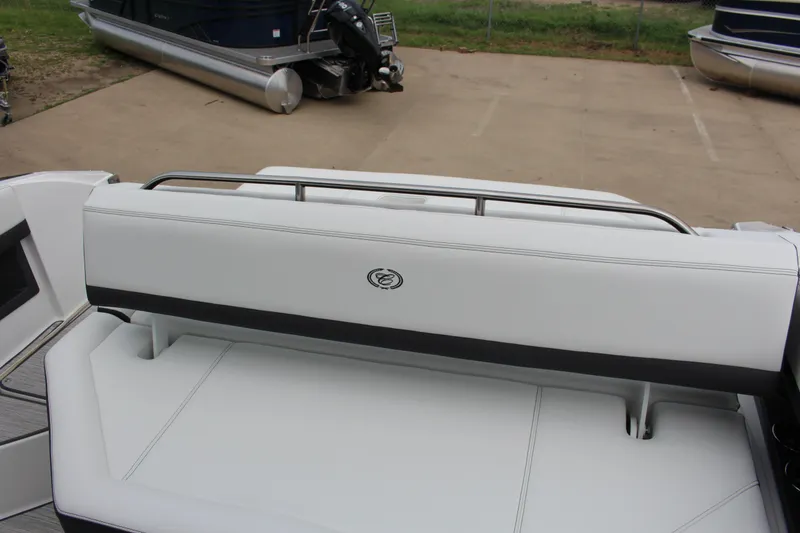 Slide: The Image of 2025 Cobalt R8 boat with white seating and sleek design in a marina setting. - 14