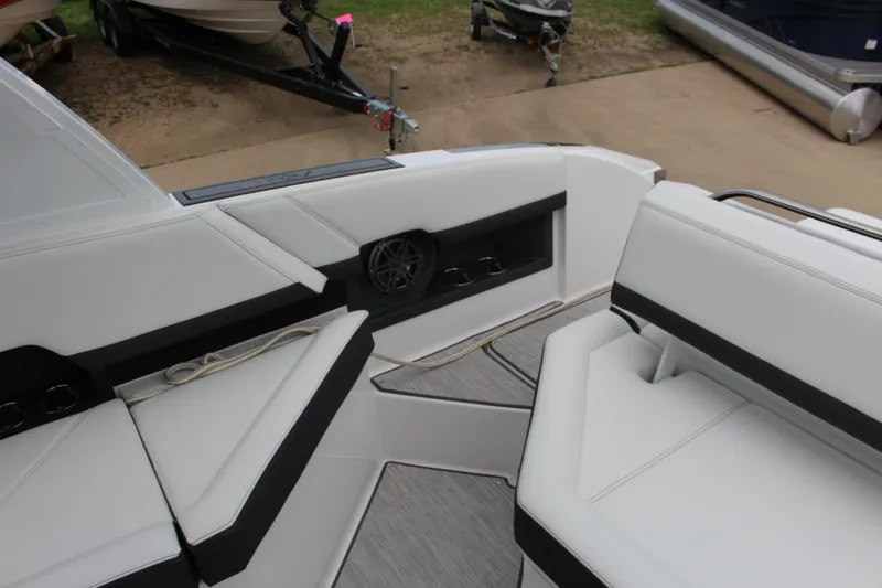 Slide: The Image of 2025 Cobalt R8 boat interior with white seating and speaker system. - 15