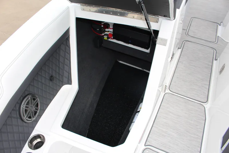 Slide: The Image of 2025 Cobalt R8 boat interior storage compartment with speaker and cup holder. - 19