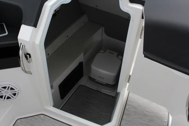 Slide: The Image of 2025 Cobalt R8 boat interior with compact toilet and storage area. - 22