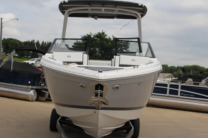 Slide: The Image of 2025 Cobalt R8 boat with sleek design, parked on a trailer at a marina. - 3