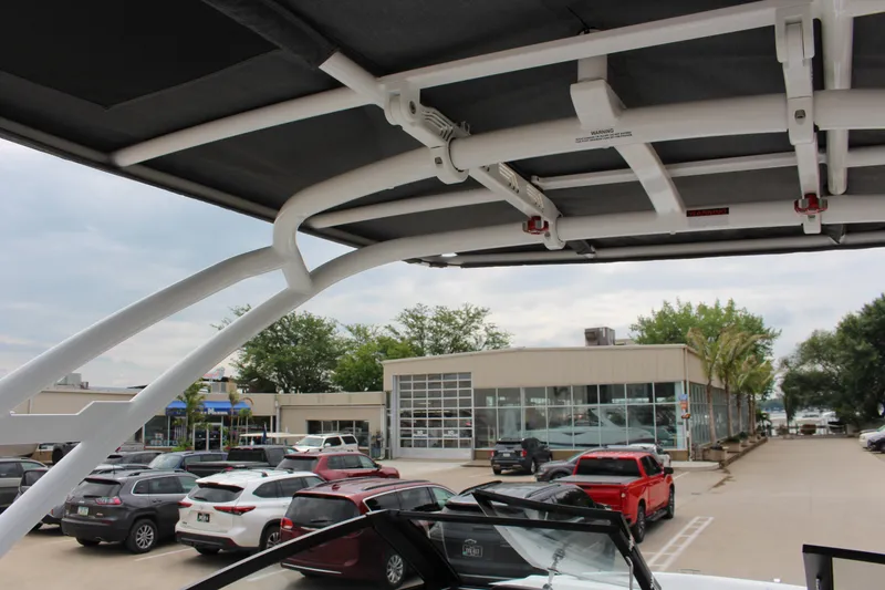 Slide: The Image of 2025 Cobalt R8 boat with canopy, parked in a busy dealership lot. - 35