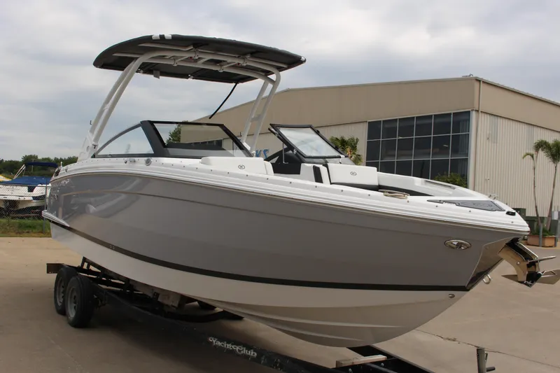 Slide: The Image of 2025 Cobalt R8 boat on trailer, sleek design, parked outdoors near industrial building. - 4