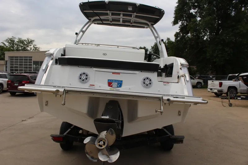 Slide: The Image of 2025 Cobalt R8 boat rear view, showcasing propeller and sleek design in a parking lot. - 7