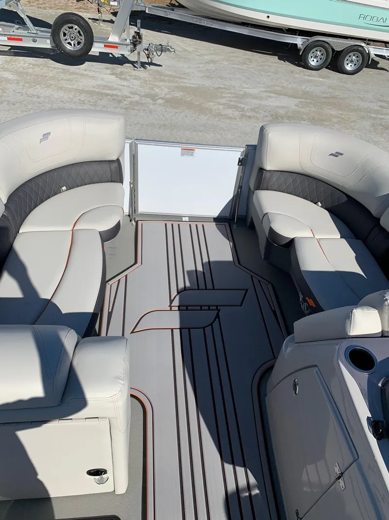 Slide: The Image of 2024 Starcraft SLS3 pontoon boat interior with plush seating and modern design. - 6