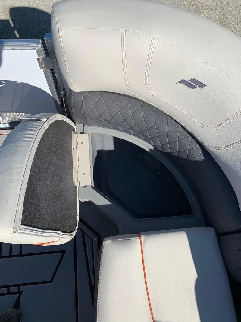 Slide: The Image of 2024 Starcraft SLS3 boat with open storage compartment and cushioned seating. - 7