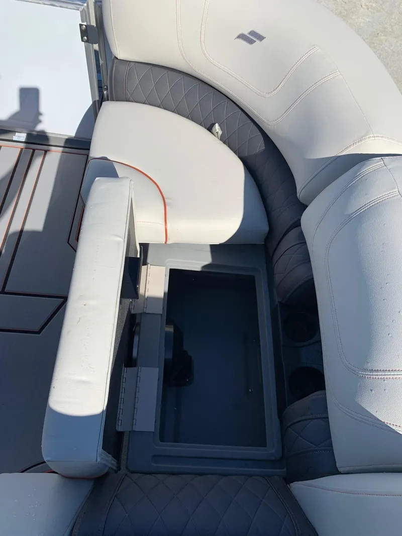 Slide: The Image of 2024 Starcraft SLS3 boat interior with open storage compartment and cushioned seating. - 9