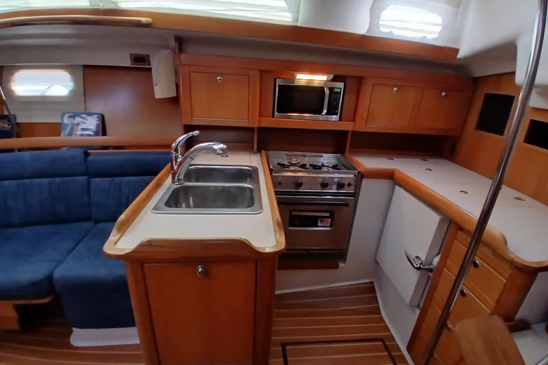 Slide: The Image of Interior of 2003 Catalina 350 yacht kitchen with sink, stove, and microwave. - 10