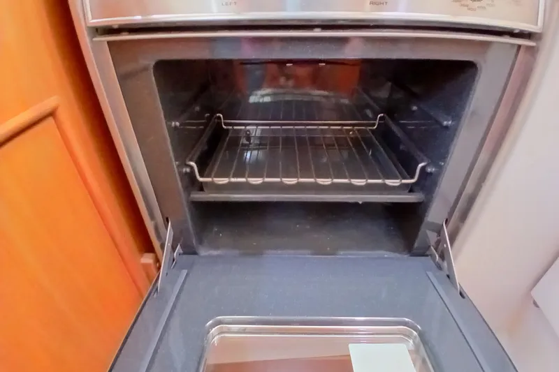 Slide: The Image of Open oven inside a 2003 Catalina 350 boat kitchen. - 11