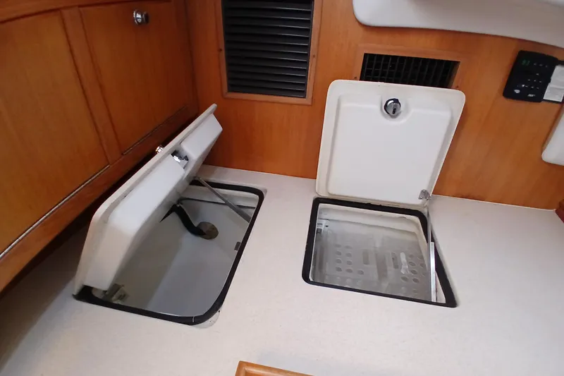 Slide: The Image of Open storage compartments in a 2003 Catalina 350 yacht interior. - 15
