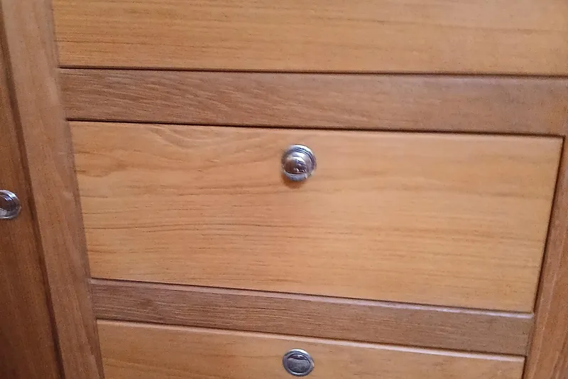Slide: The Image of Wooden cabinet drawers with metal knobs in a 2003 Catalina 350 boat interior. - 22