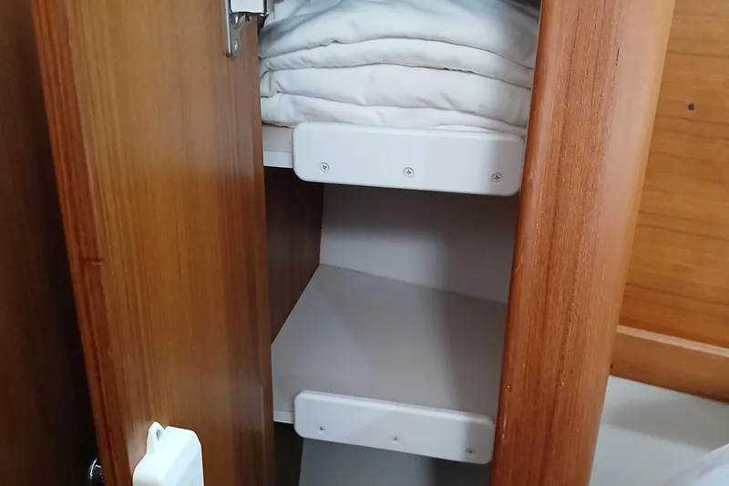 Slide: The Image of Wooden cabinet with shelves inside a 2003 Catalina 350 sailboat. - 25