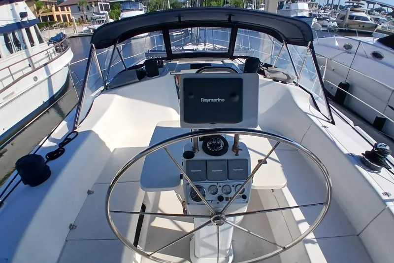 Slide: The Image of Cockpit of 2003 Catalina 350 sailboat with steering wheel and navigation equipment. - 3
