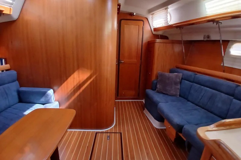 Slide: The Image of Interior of 2003 Catalina 350 sailboat with blue seating and wooden finishes. - 6