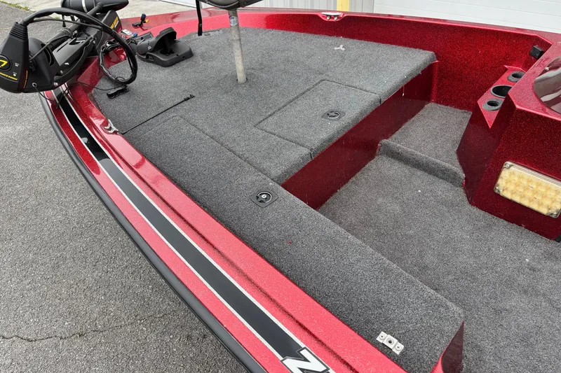 Slide: The Image of 1995 Hydra-Sports Z260 boat interior with red and gray design, featuring carpeted deck. - 2