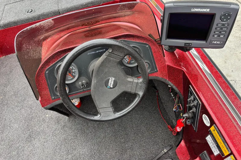 Slide: The Image of 1995 Hydra-Sports Z260 boat dashboard with steering wheel and Lowrance HDS7 fishfinder. - 5