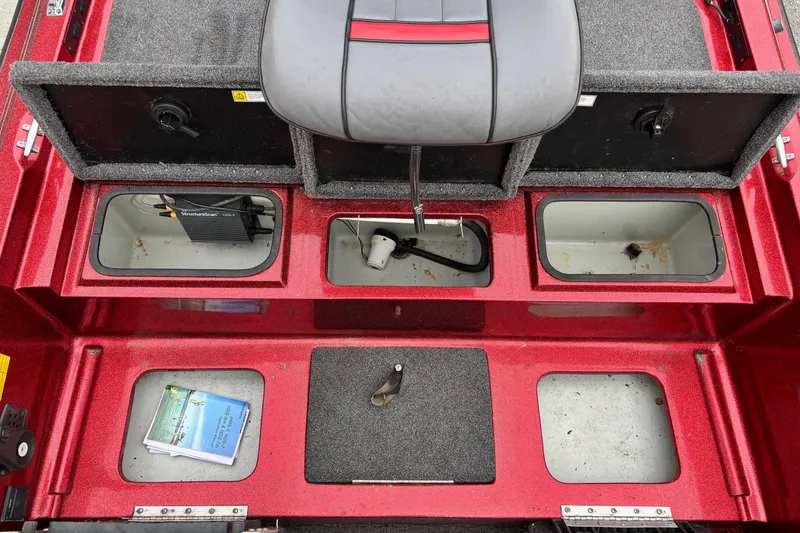 Slide: The Image of Interior view of a 1995 Hydra-Sports Z260 boat, featuring storage compartments and seating. - 7