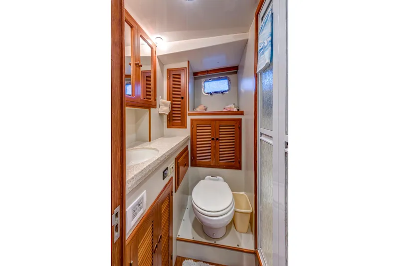 Slide: The Image of 2007 Krogen 44' Widebody yacht bathroom with wooden cabinetry and modern fixtures. - 12