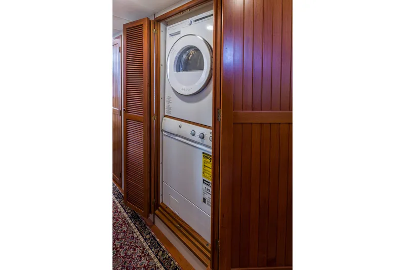 Slide: The Image of Stacked washer and dryer in wooden closet on 2007 Krogen 44' Widebody yacht. - 13