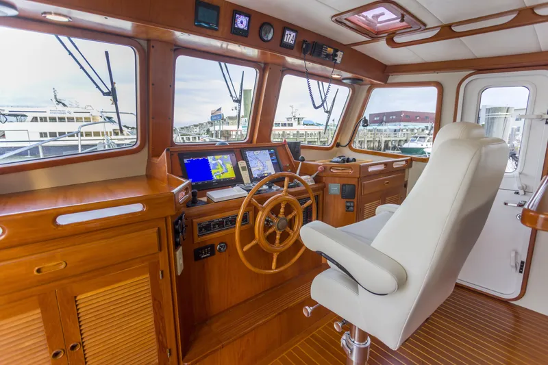 Slide: The Image of Luxurious 2007 Krogen 44' Widebody yacht helm with wooden accents and modern navigation equipment. - 17