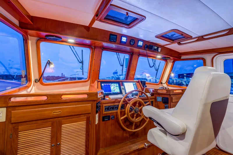 Slide: The Image of Pilothouse of 2007 Krogen 44' Widebody yacht with wooden helm and navigation equipment. - 19