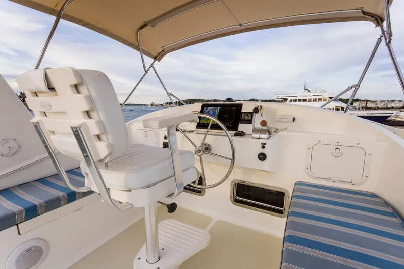 Slide: The Image of 2007 Krogen 44' Widebody helm with white captain's chair and navigation equipment. - 23