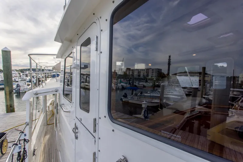 Slide: The Image of 2007 Krogen 44' Widebody yacht docked at marina, reflecting waterfront view. - 27