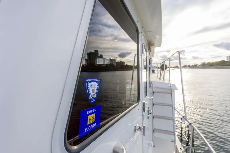 Slide: The Image of 2007 Krogen 44' Widebody yacht with safety check sticker, docked in Florida waters. - 28